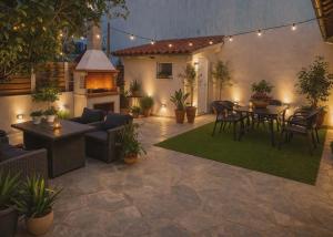 a patio with a table and chairs and a fireplace at Secret Garden Volos in Volos