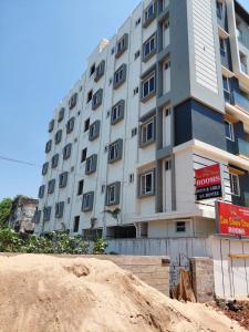 a building on the beach in front of a building at sea shore stays in Rushikonda