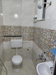 a bathroom with a toilet and a sink at sea shore stays in Rushikonda