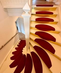 a spiral staircase with red carpeting in a house at CASA Salzburg in Salzburg +2 photos