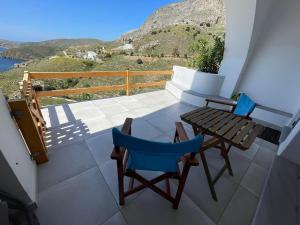 a balcony with a table and chairs and a view at Shaunagh's Place Crag Apartment in Kalymnos