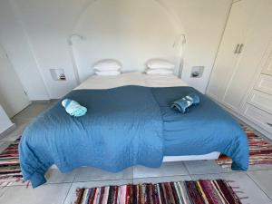 a blue bed with two pillows on top of it at Shaunagh's Place Crag Apartment in Kalymnos