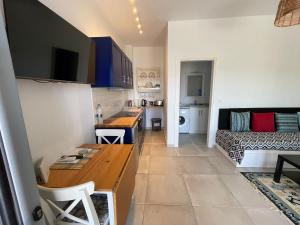 a kitchen and living room with a table and a couch at Shaunagh's Place Crag Apartment in Kalymnos +12 photos