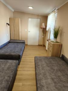 a large room with two beds and a door at U Władzia in Gowidlino