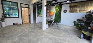 an empty garage with a table and chairs in it at Skudai - The9 Homestay 1min UTM, near Sutera Mall, Paradigm Mall, Senai airport in Skudai