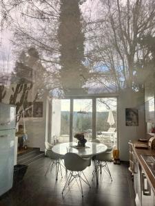 a kitchen with a table and chairs and a large window at Weitblick am Mangfalltal in Feldkirchen-Westerham