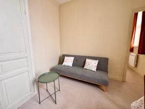 a living room with a couch and a table at Le Repère de Rumaucourt in Rumaucourt