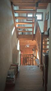 a staircase in a house with wooden ceilings at Le Jardingue - Chambres d'Hôtes in Saint-Moreil