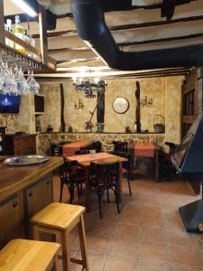 a restaurant with tables and chairs in a room at Hotel Rural Papasol in Atapuerca