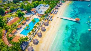 an aerial view of a beach with a resort at Coral Cove Oasis in Discovery Bay
