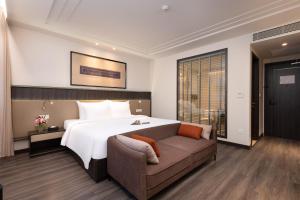 a bedroom with a large bed and a couch at Hotel Montmartre de Sapa - Newly Opened April 2026 in Sapa