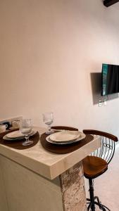 a table with two plates and wine glasses on it at Villa di Trevi Hospedagem em Pedra Azul in Domingos Martins +76 photos