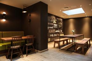 a restaurant with two tables and chairs and a chalkboard wall at hub London - Spitalfields in London