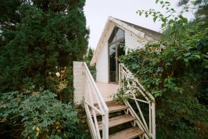 a tiny house with stairs leading up to it at Veco Pine in Thạch Cầu