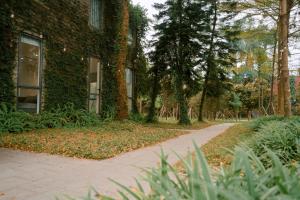 a walkway in front of a building with trees at Veco Pine in Thạch Cầu