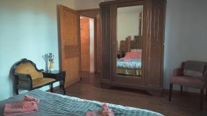 a bedroom with two beds and a mirror at Le Jardingue - Chambres d'Hôtes in Saint-Moreil +5 photos