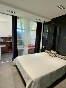 a bedroom with a large bed and a large window at Magnifique vue mer - 2 pièces climatisé avec terrasse à Cap Estérel in Saint-Raphaël +20 photos