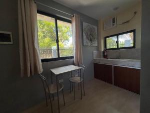 a kitchen with a table and chairs and a sink at Residencia de rubie 2 in Dahikan