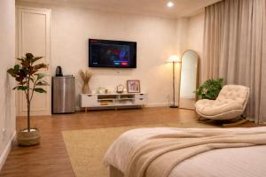 a bedroom with a bed and a tv on the wall at Homemie in Binh Hai