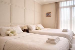 a bedroom with two beds with teddy bears on them at Homemie in Binh Hai