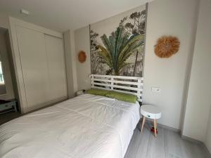 a bedroom with a white bed and a painting on the wall at Apartamento Domara Vera in Vera +37 photos