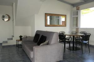 a living room with a couch and a table at Villa Diams Diamond in Le Diamant +15 photos