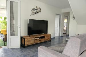 a living room with a flat screen tv and a couch at Villa Diams Diamond in Le Diamant