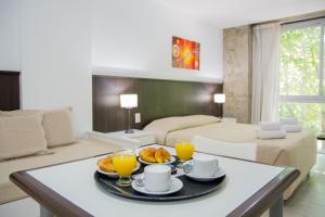 a living room with a table with breakfast foods on it at Torre Potosi Departamentos in Rosario