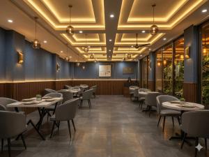 a dining room with tables and chairs and a podium at Hotel Grand Gtois -Delhi Airport in Dunya