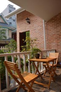 a wooden table and two chairs on a balcony at Kết nối home in Hai Phong