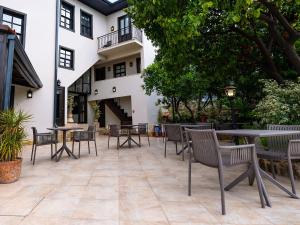 a patio with tables and chairs in front of a building at Morea Kaleiçi-Adults Only in Antalya +27 photos