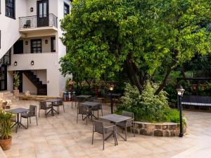 a courtyard with tables and chairs and a tree at Morea Kaleiçi-Adults Only in Antalya