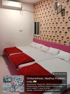 a bed in a room with avertisement for at Hotel Sadashiv in Godarpura