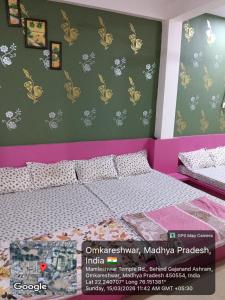 a bedroom with a bed and a green wall at Hotel Sadashiv in Godarpura