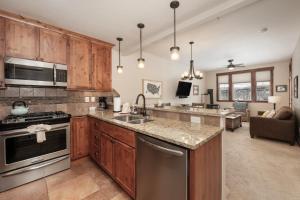 a kitchen with wooden cabinets and stainless steel appliances at Cozens Pointe Building G Unit 202 in Fraser