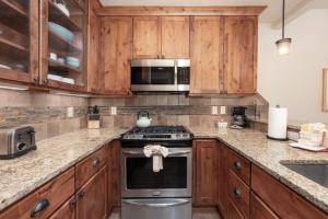 a kitchen with a stove and a microwave at Cozens Pointe Building G Unit 202 in Fraser