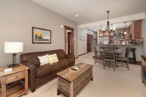 a living room with a brown couch and a table at Cozens Pointe Building G Unit 202 in Fraser