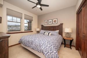 a bedroom with a bed and a ceiling fan at Cozens Pointe Building G Unit 202 in Fraser +13 photos