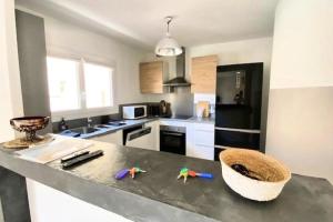 a kitchen with a counter top with toys on it at Spacious house with balcony in Sainte-Maxime