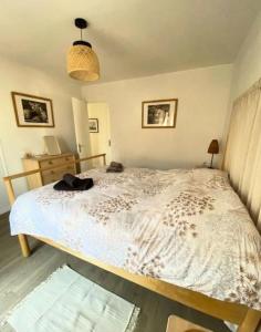 a bedroom with a bed with a white comforter at Spacious house with balcony in Sainte-Maxime +5 photos