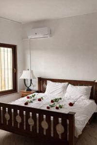 a bedroom with a bed with roses on it at ANDA villa&Farm in Amman