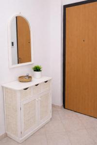 a bathroom with a sink and a mirror and a door at A Mare in Vasto
