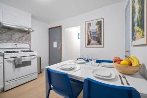a kitchen with a table with a bowl of fruit on it at Cozy 4BD Unit in Lower Manhattan in New York