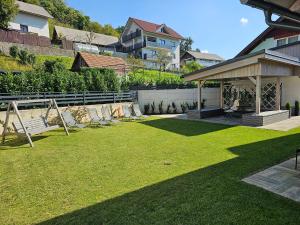 a yard with chairs and a gazebo at Prima Countryside Apartments near Bled in Žirovnica