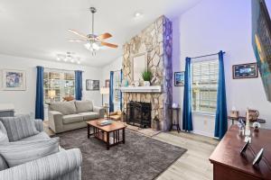 a living room with a couch and a fireplace at Whispering Marsh Hideaway - Peaceful House in Myrtle Beach