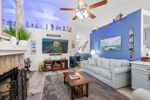 a living room with a couch and a ceiling fan at Whispering Marsh Hideaway - Peaceful House in Myrtle Beach