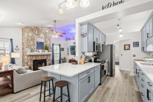 a kitchen with white cabinets and a living room at Whispering Marsh Hideaway - Peaceful House in Myrtle Beach +46 photos