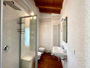 a bathroom with a sink and a toilet at Villa Gardoncino in Manerba del Garda +95 photos