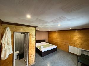a room with a bed and a shower and a bathroom at Paulownia Garden in Mtskheta