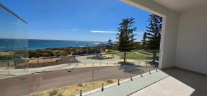 a large glass balcony with a view of the ocean at Coastal Calm Seascapes unit 2 in Falcon